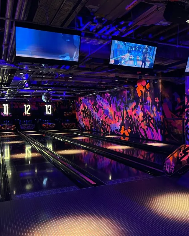 Neon-lit bowling lanes in a leisure venue